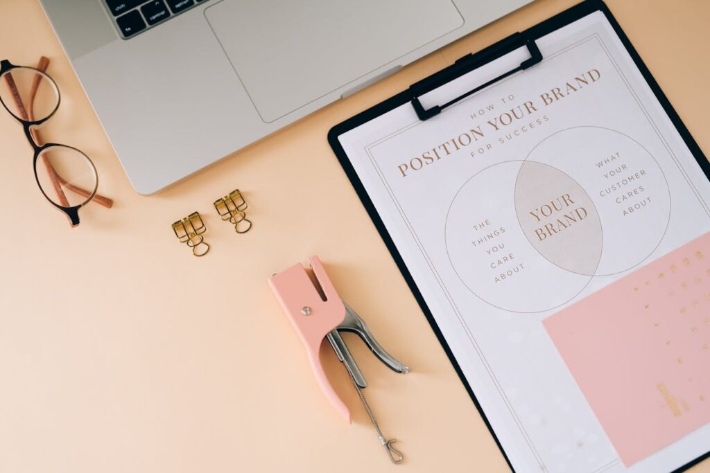 pexels-photo-8970684 A flat lay composition featuring office essentials and a branding strategy clipboard on a modern workspace.